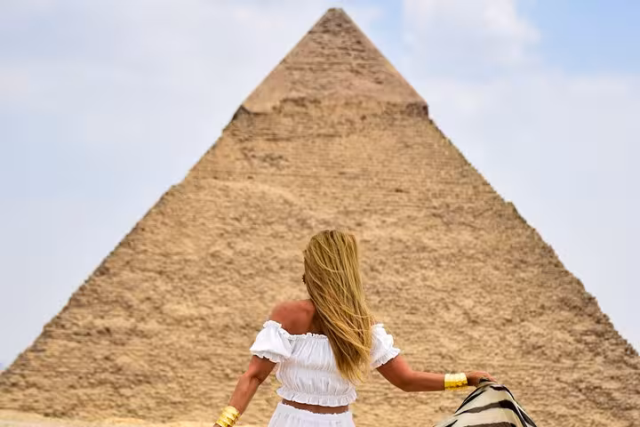 Traveler at the Great Pyramid of Giza on a Hurghada to Cairo day trip, pyramids and Grand Museum tour