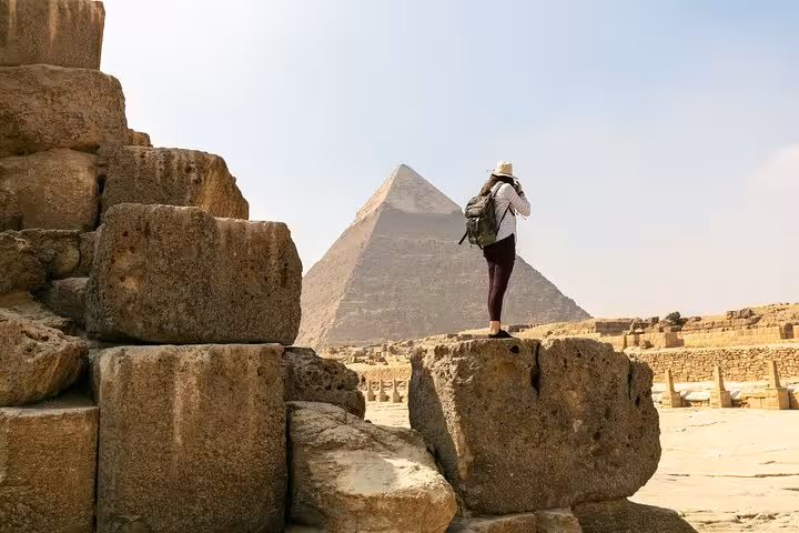 Traveler photographing the Great Pyramid of Giza on Cairo day trip from Hurghada, pyramids tour