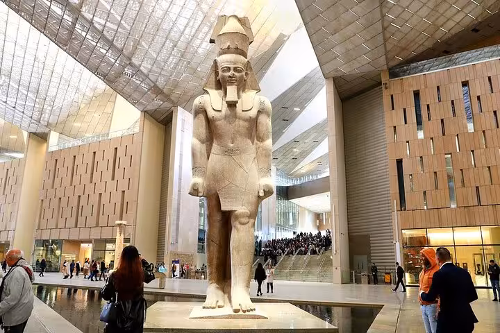 Grand Egyptian Museum Cairo statue hall visit on Hurghada day tour with pyramids and Sphinx