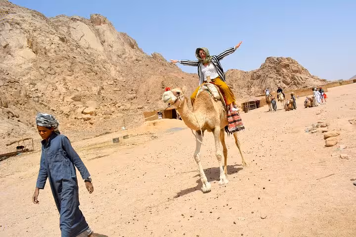 Traveler on camel ride in Hurghada desert safari, scenic mountains stop on 3-hour quad bike tour