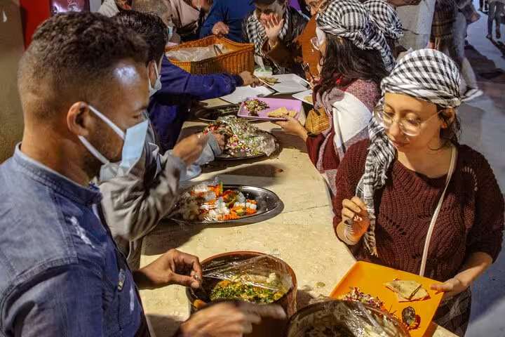 Guests enjoy Bedouin dinner buffet after Hurghada desert ATV and buggy safari, tasting grilled Egyptian dishes