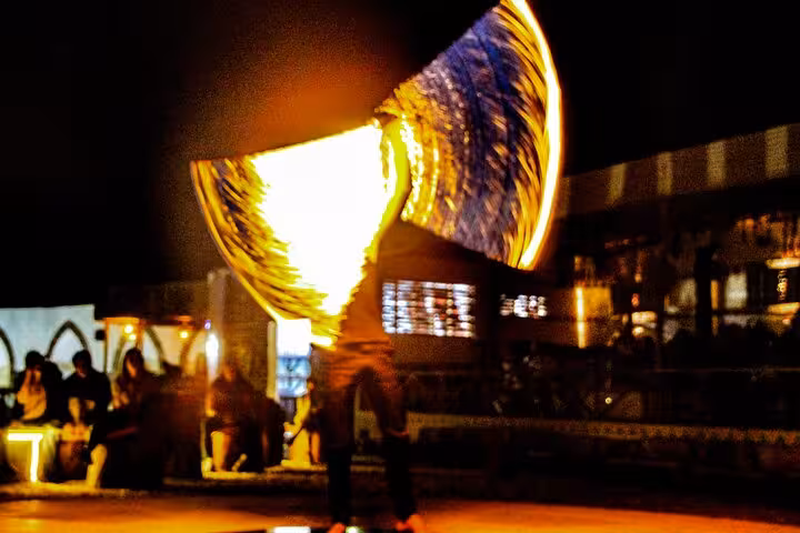 Fire dancer spinning flames at Hurghada desert camp dinner show after ATV and buggy safari adventure