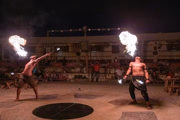 Fire-breathing performers at Hurghada desert safari dinner show after ATV and buggy adventure in Egypt