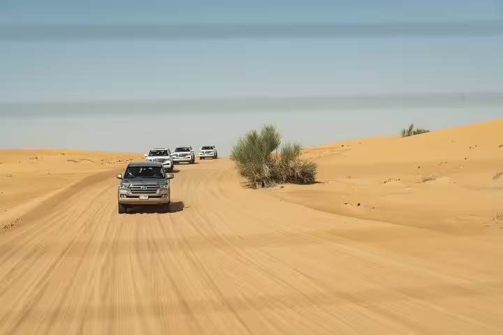 4x4 jeeps convoy crossing Hurghada desert dunes on Bedouin safari tour with quad bike and camel ride