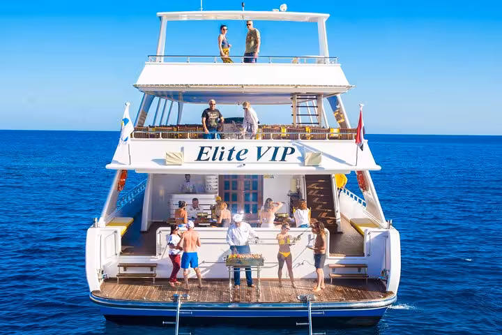 Rear view of Hurghada Elite VIP cruise yacht with onboard BBQ grill and guests on Red Sea day trip