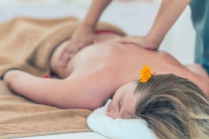 Relaxing full-body massage in Hurghada spa with towel bed and aromatherapy flower, wellness package