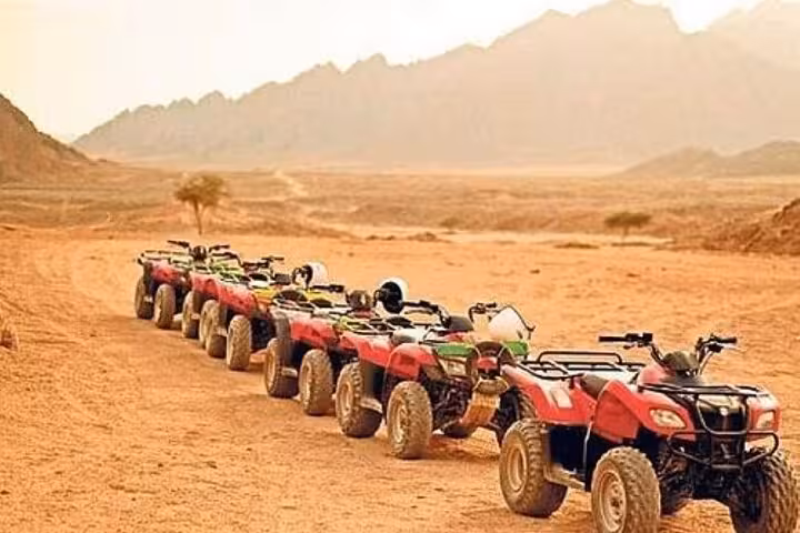 Line of ATVs in Hurghada desert ready for Jeep Super Safari and quad bike ride to Bedouin village dinner show