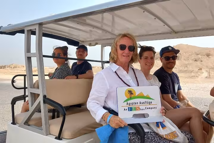Tourists ride a shuttle in the desert on Hurghada to Luxor Valley of the Kings and Tutankhamun tomb tour