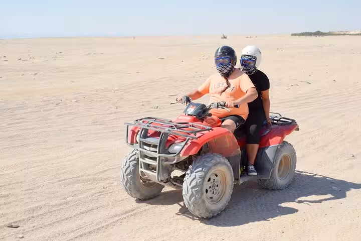 Two riders on ATV quad bike in Hurghada desert on 3-hour safari adventure with camel ride and shopping
