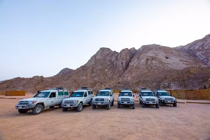 4x4 safari vehicles lined up in Hurghada desert mountains, meeting point for quad bike, camel ride and shopping