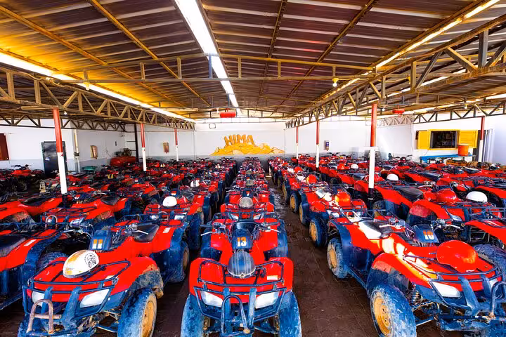 Rows of red quad bikes at Hurghada desert safari station for Jeep Super Safari and Bedouin village tour