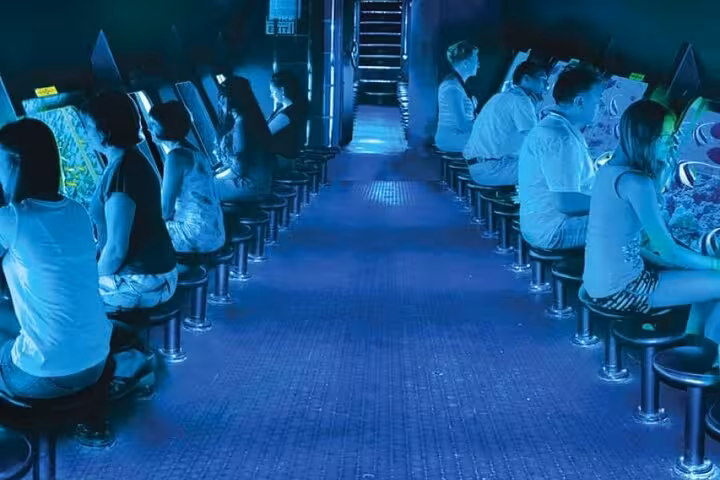 Passengers seated by panoramic windows inside Hurghada semi-submarine, viewing Red Sea coral reef marine life