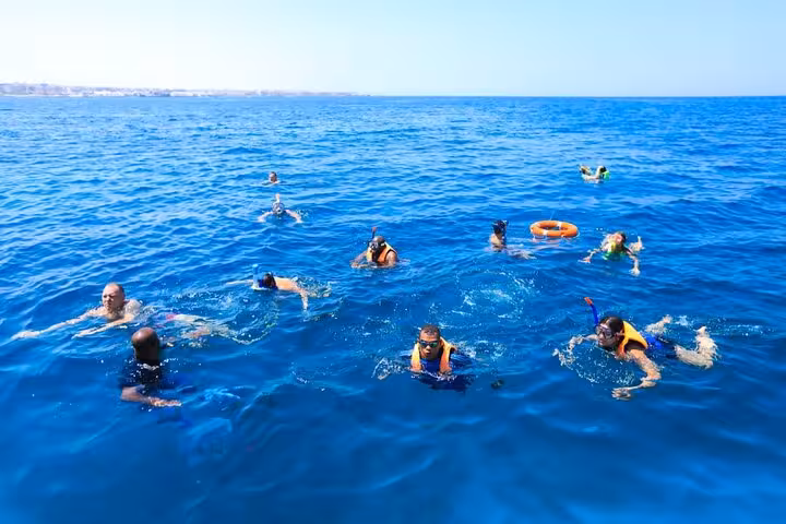 Snorkelers floating in the Red Sea during Hurghada 2-hour semi-submarine tour with swim stop
