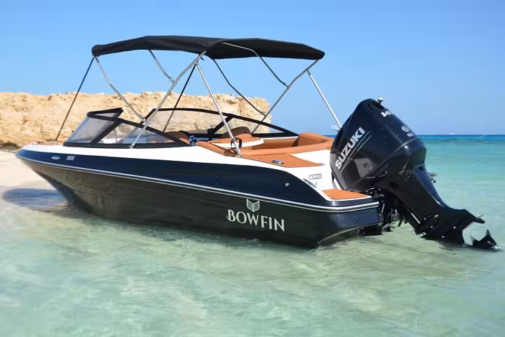 Hurghada private speedboat with canopy and Suzuki engine in crystal-clear Red Sea, dolphin watching trip