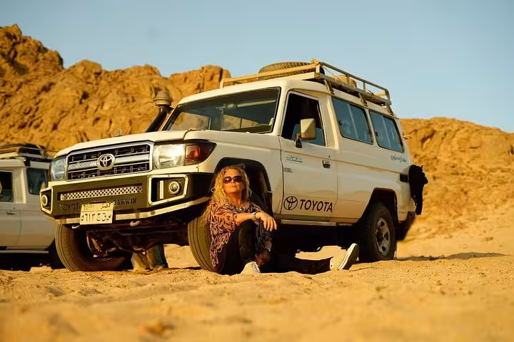 4x4 jeep in Hurghada desert with traveler resting, part of stargazing adventure with optional ATV ride