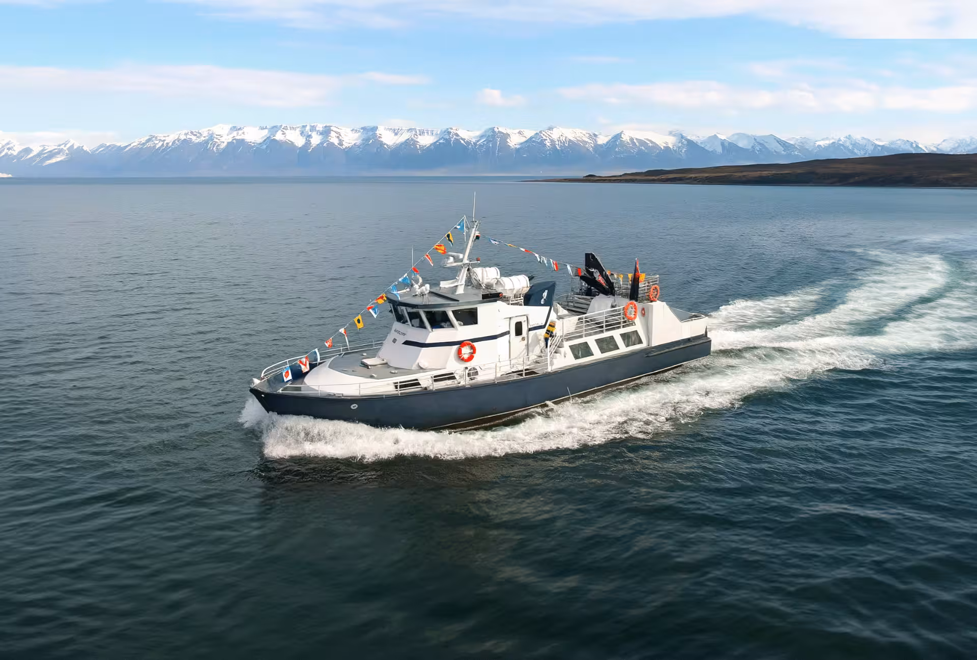 Locally owned Húsavík whale watching boat moored at the harbor, ready for a guided family-friendly tour in Iceland