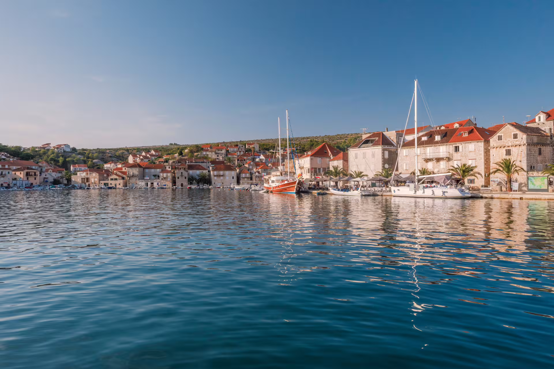 Harbor view with sailboats and stone waterfront, ideal stop on Hvar Brac Pakleni private boat tour