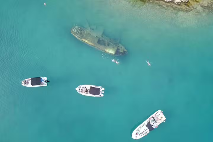 Aerial view of boats by a shipwreck in turquoise Adriatic near Brac, stop on Hvar Brac Solta tour