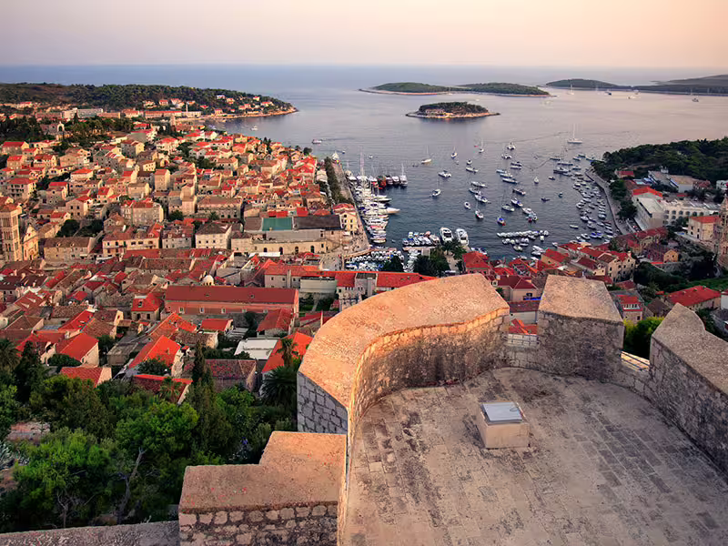 Sunset view over Hvar Town harbor and yachts, a must-see stop on the Hvar Brac Pakleni private boat tour