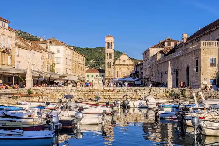 Hvar Town waterfront harbor with boats and historic stone buildings on Golden Horn Beach & Paklinski Islands tour