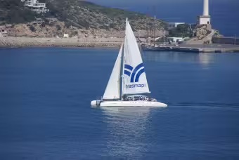 Catamaran near Ibiza coastline on the way to Illetes beach, Formentera day trip with lunch on board