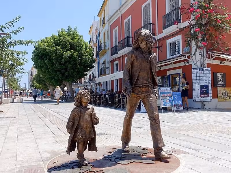 Bronze street statues on Ibiza Town promenade near Dalt Vila, a stop on the guided night walking tour