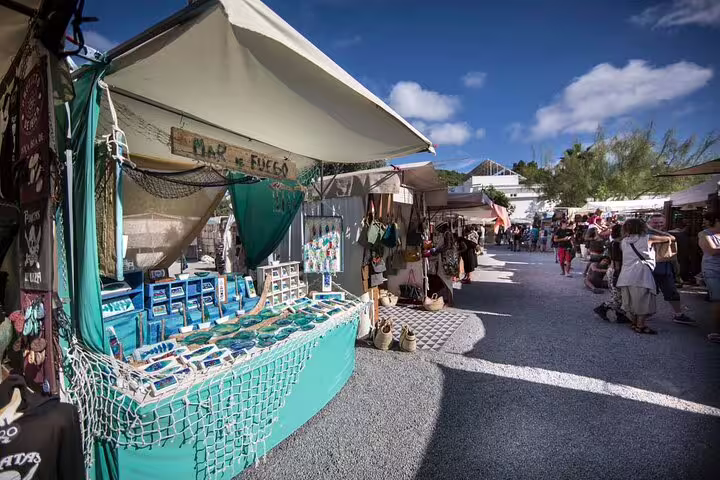 Ibiza hippie market street with artisan stalls and souvenirs, visited on island bus tour with official guide