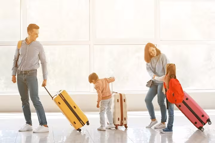 Family with suitcases in bright terminal using Ibiza luggage storage service for hands-free sightseeing