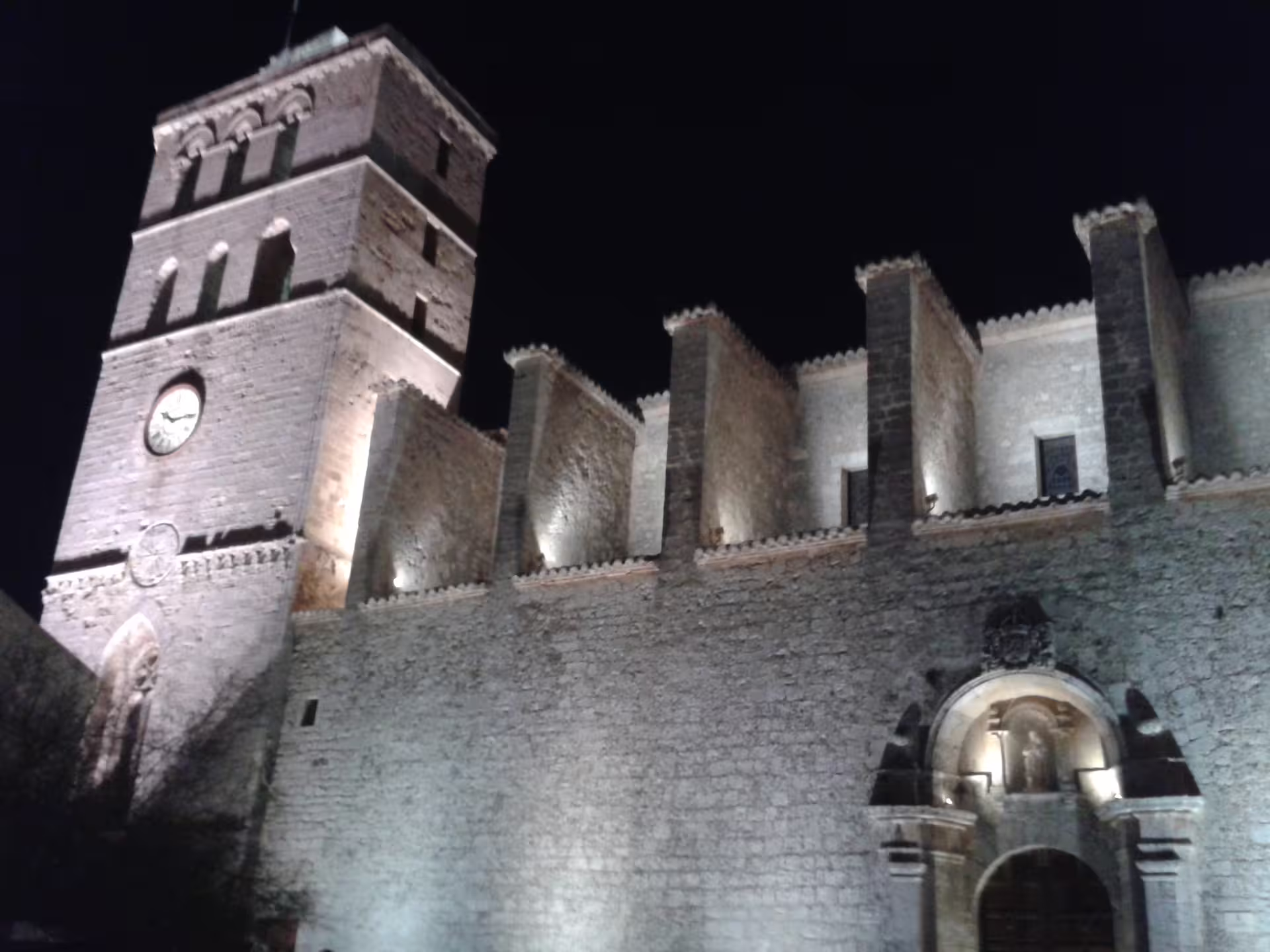 Illuminated Dalt Vila cathedral walls at night, seen on Ibiza Night hotel-to-port transfer with guide