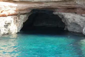 Turquoise sea cave on Ibiza boat trip from San Antonio to Es Vedrà with guide, aperitif and drinks included