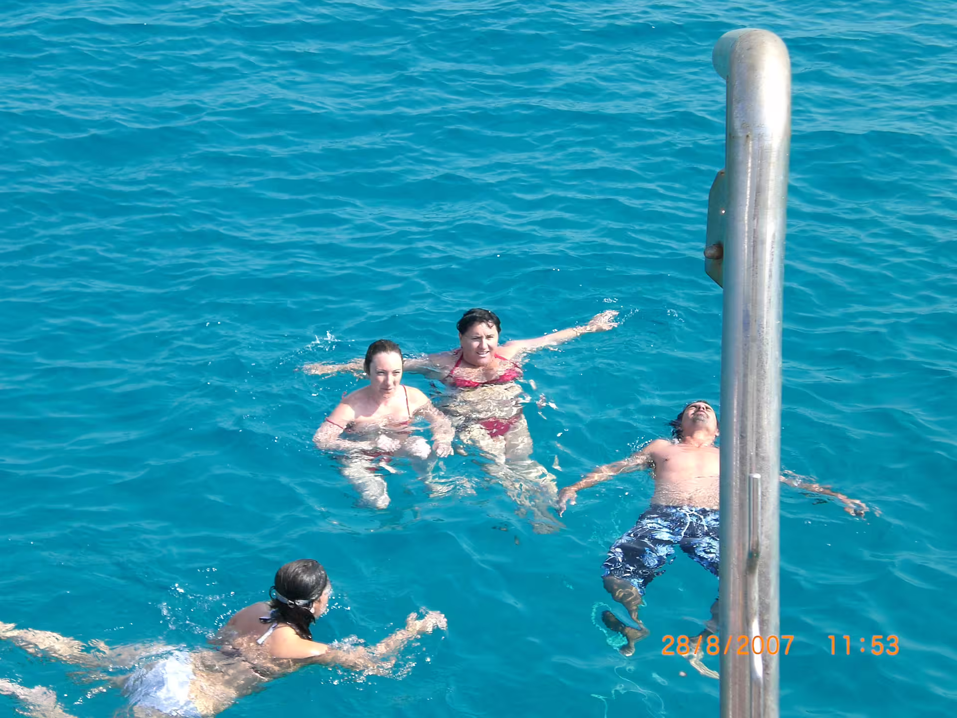 Guests swimming in turquoise Ibiza sea during San Antonio to Es Vedrà guided boat excursion with drinks included