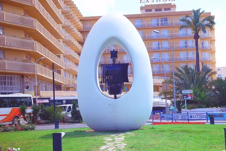 Modern white monument in Ibiza town roundabout, photo stop on Ibiza island bus tour with official guide