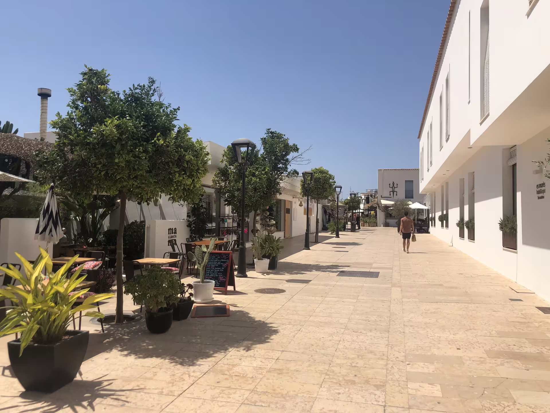 Sunny pedestrian street in Ibiza town, a stop on the Ibiza bus tour with fast ferry and official guide