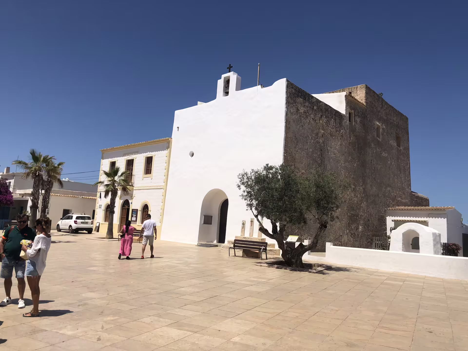 Whitewashed Ibiza church and historic square visited on Ibiza bus tour from Ibiza with fast ferry and official guide