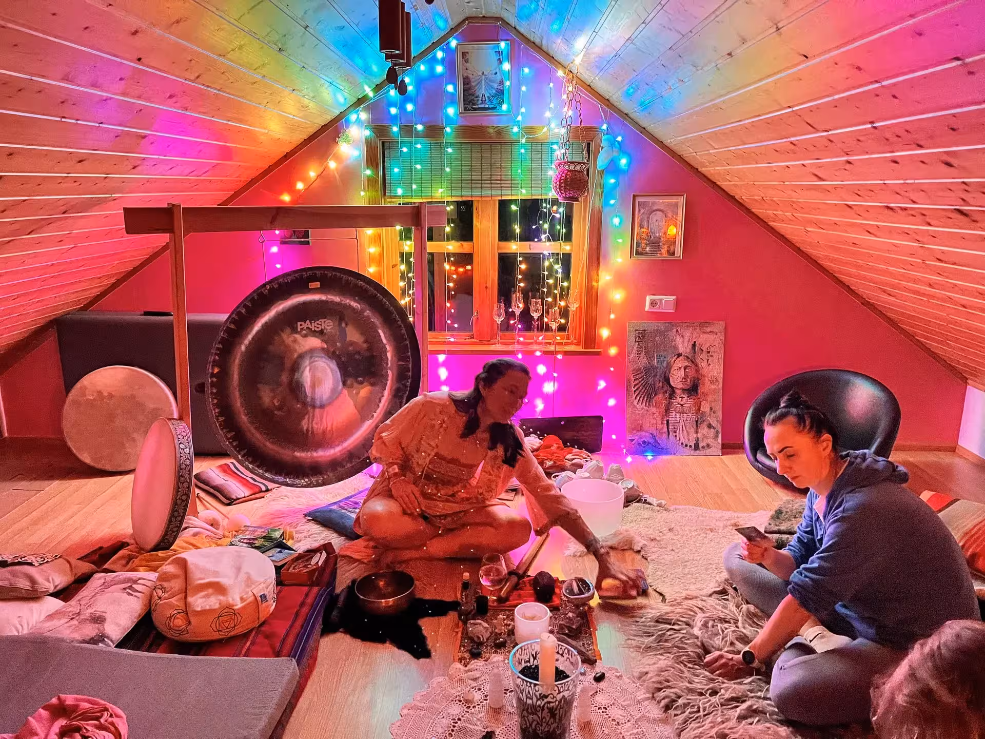 Group cacao ceremony with sound bath gong and crystal bowls in Iceland, cozy Christmas retreat atmosphere