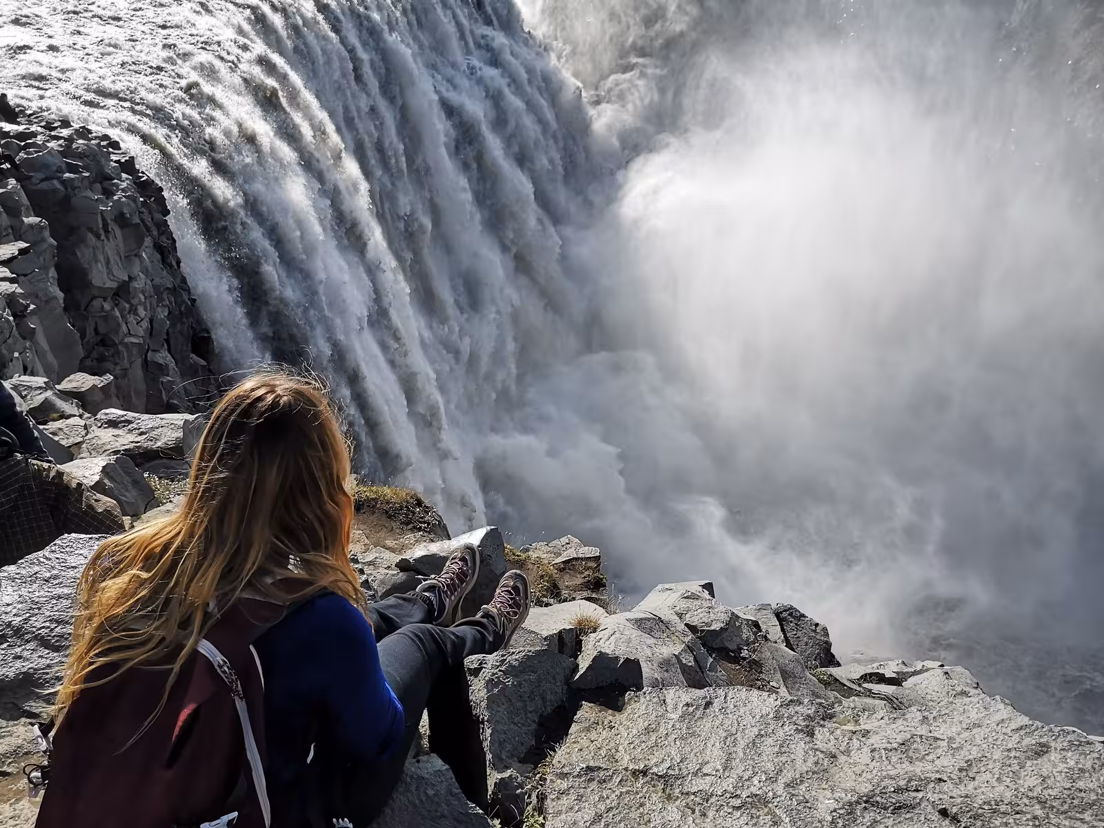 Traveler admires the powerful Dettifoss waterfall during the Complete Iceland Circle self-drive tour.