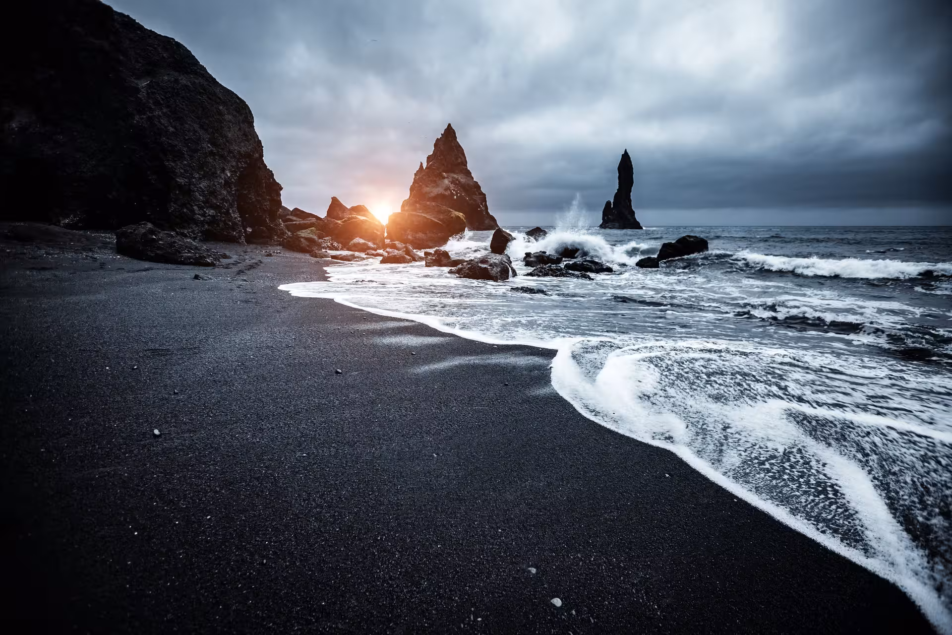 Dramatic sunset over Reynisfjara black sand beach during Iceland's self-drive adventure.