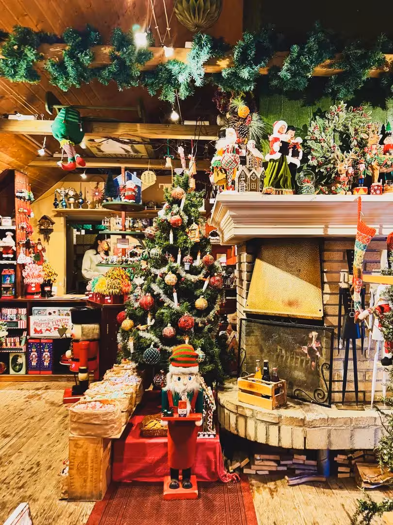 Festive Iceland Christmas shop with tree and fireplace, holiday magic stop on private Goðafoss day tour