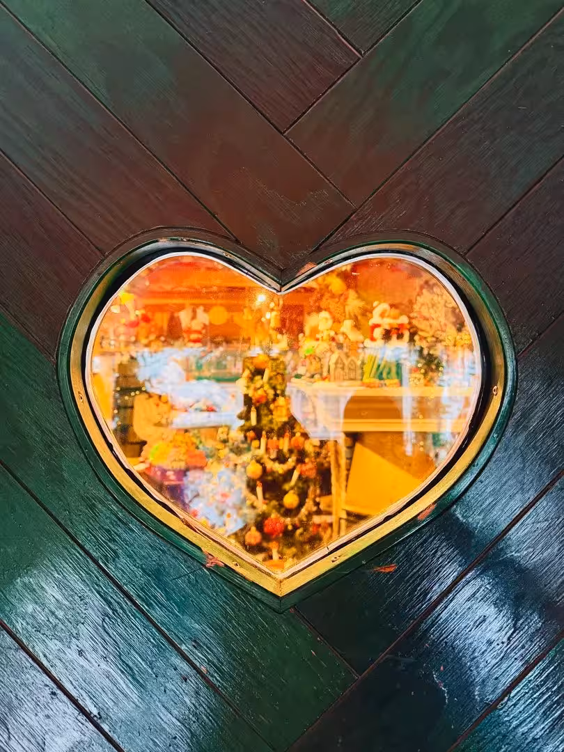 Heart-shaped window glowing with Christmas lights, cozy stop on private Sacred Iceland cacao ceremony tour