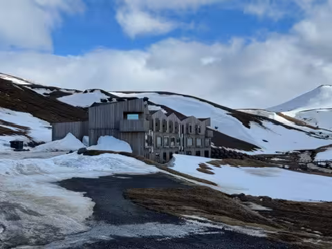 Cozy lodge nestled in the snow-covered Icelandic Highlands, perfect for a winter wellness retreat.
