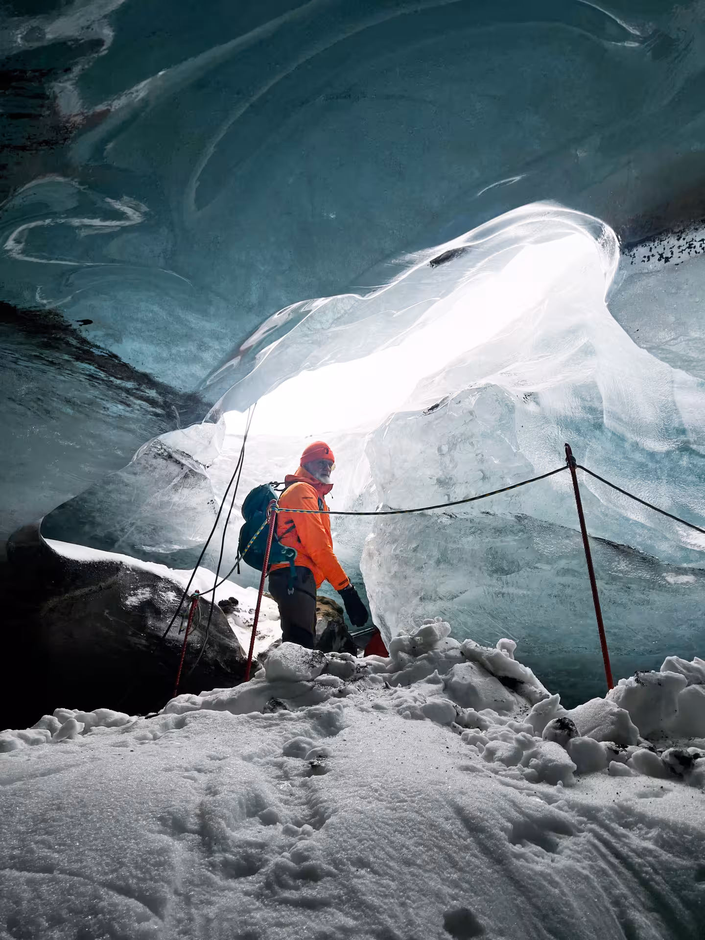 Traveler entering blue ice cave on guided Iceland tour, Golden Circle & ice cave monster truck from Reykjavik