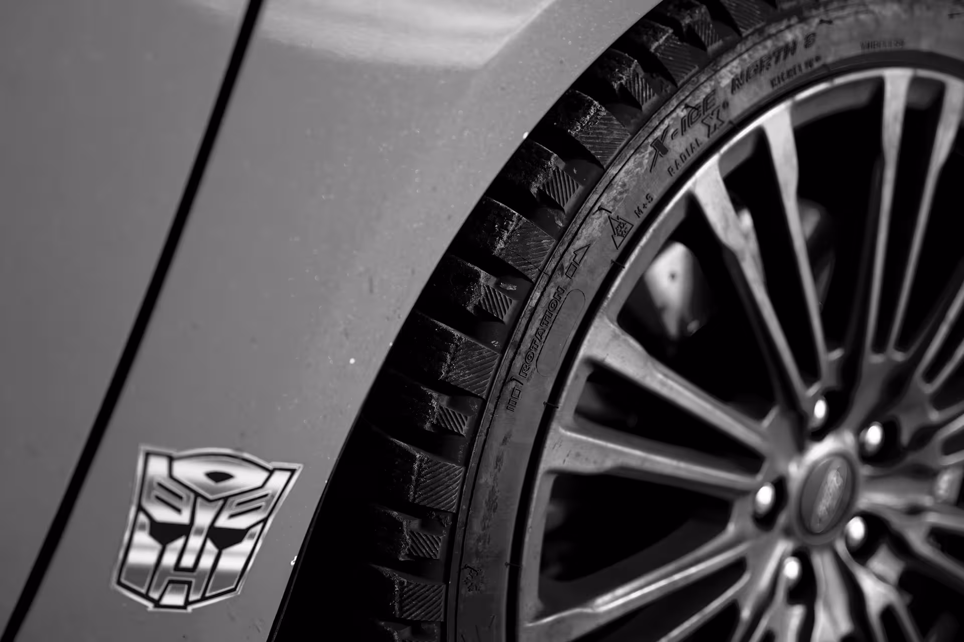 Studded winter tire and alloy wheel of Iceland rally car taxi for private airport transfer from Keflavik