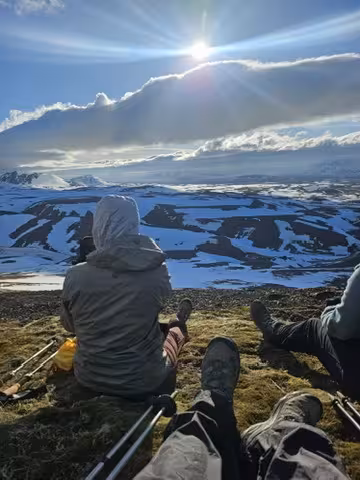 Women enjoying a serene view of the Icelandic Highlands during a winter wellness retreat.