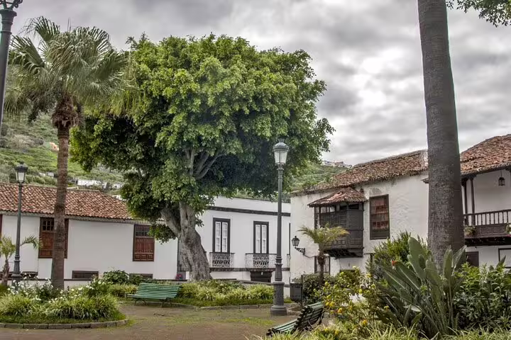 Tranquil courtyard in Icod de los Vinos, Tenerife, surrounded by traditional Canarian architecture and vibrant greenery.