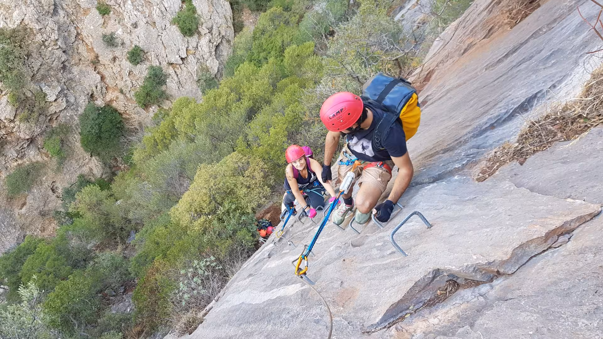 Adventurers abseiling down the rugged Gutturu Xeu canyon in Iglesias, showcasing thrilling climbing experiences.