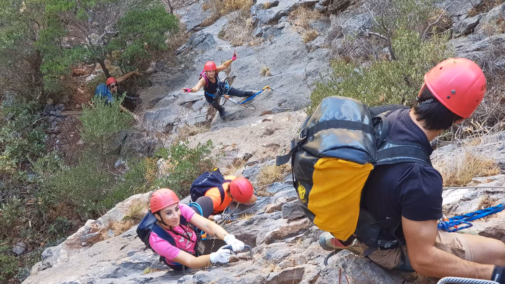 Group of climbers navigating the rocky terrain of Gutturu Xeu canyon in Iglesias, highlighting adventure and teamwork.