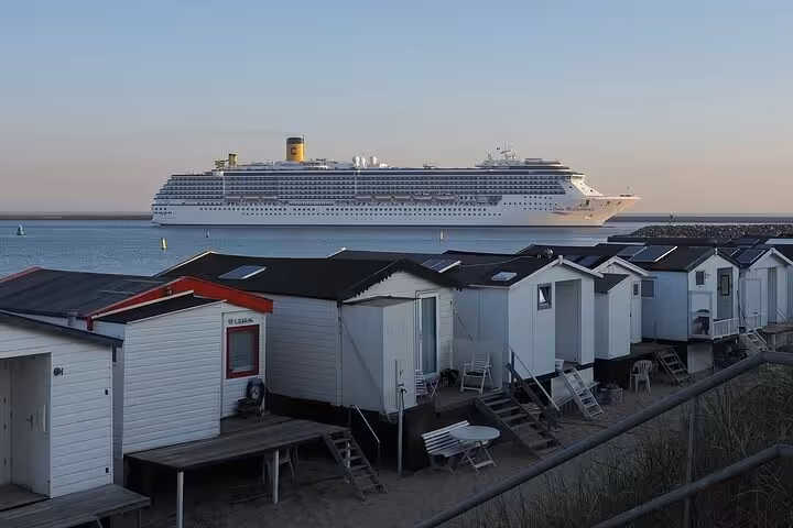 Cruise ship docked at IJmuiden port near beach cabins, ideal start for private transfer to Amsterdam
