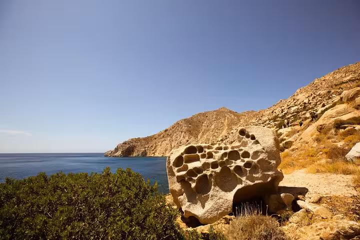 Honeycombed seaside rock and arid cliffs along Ikaria’s wild west coast near remote beaches and hiking paths