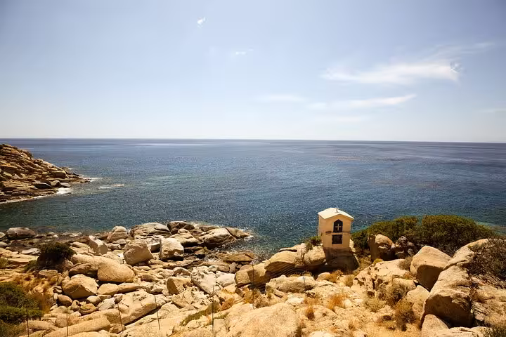 Small seaside chapel overlooks rocky coastline and shimmering Aegean Sea on Ikaria’s tranquil west side