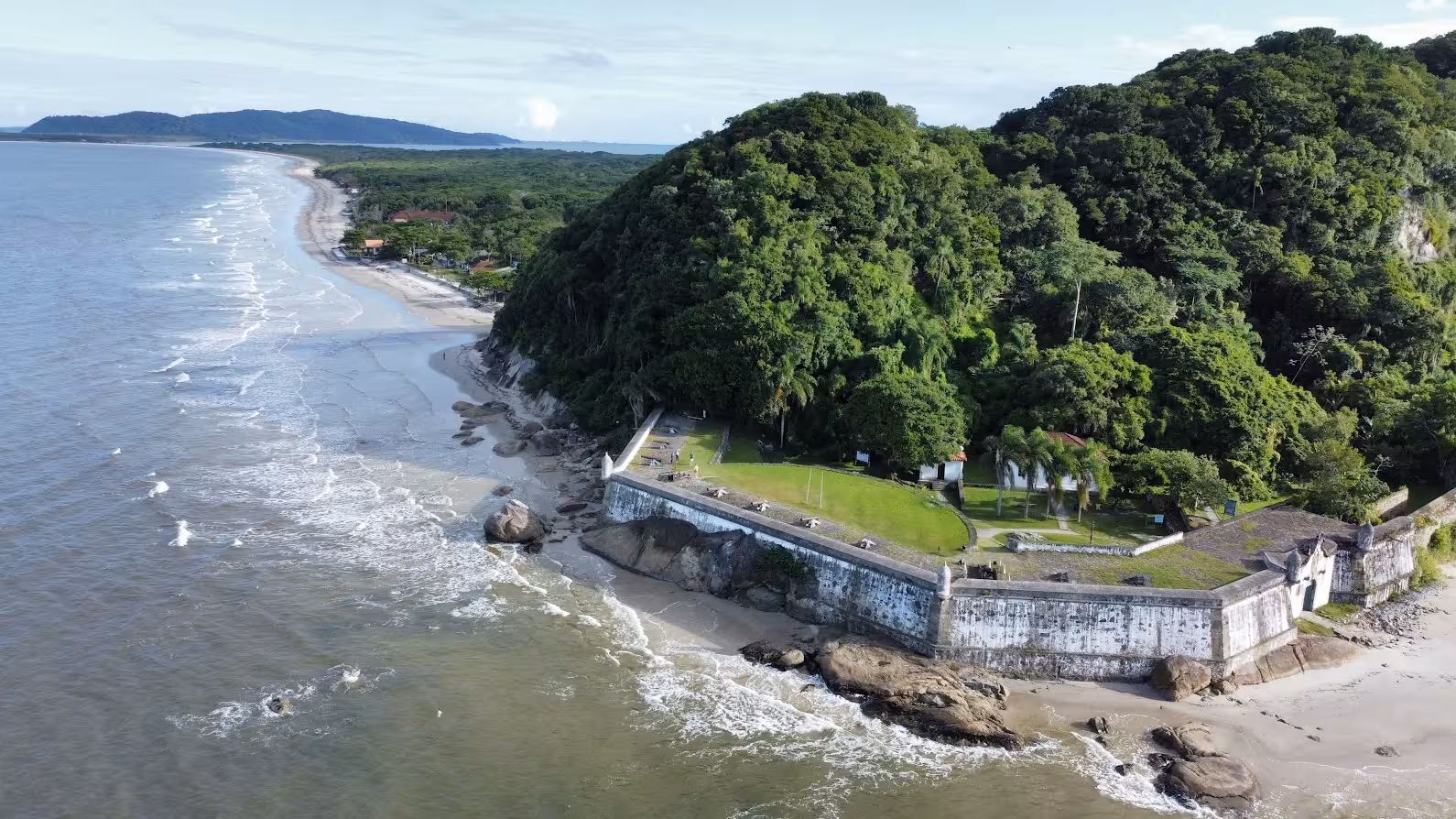 Aerial view of Ilha do Mel's lush coastline and historic fort, perfect for exploring on a private tour.